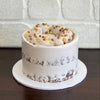 Chocolate hazelnut semi naked cake decorated with hazelnut pieces and chocolate crispearls